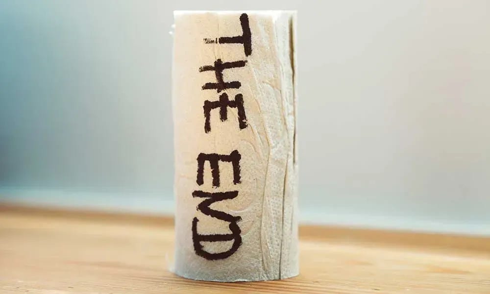 An empty toilet paper roll that says "The End."