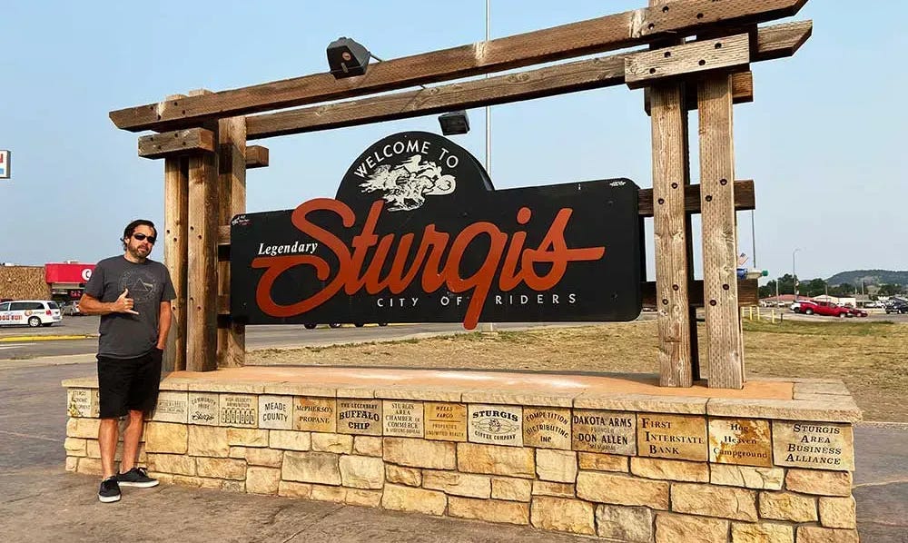 James standing in front of the Sturgis sign.